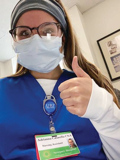 Adrianna J. Cafarella, of Little Compton, who earned her bachelor’s degree in nursing, summa cum laude in May 2021, flashes the thumbs up sign while working at Newport Hospital during the pandemic as a certified nursing assistant.